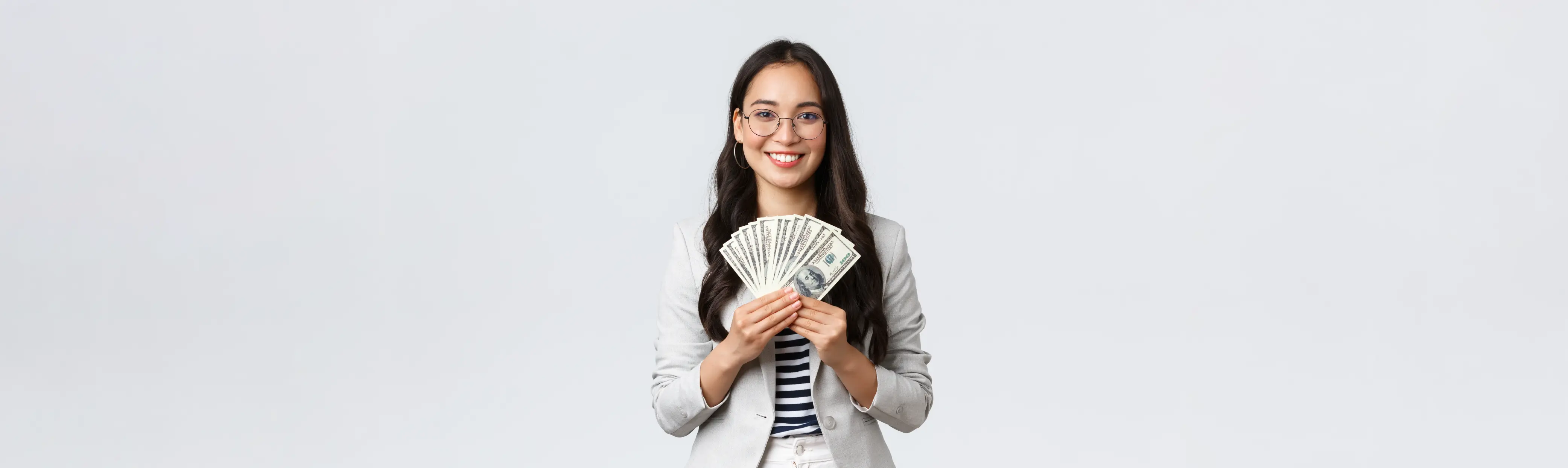 A female student holding money